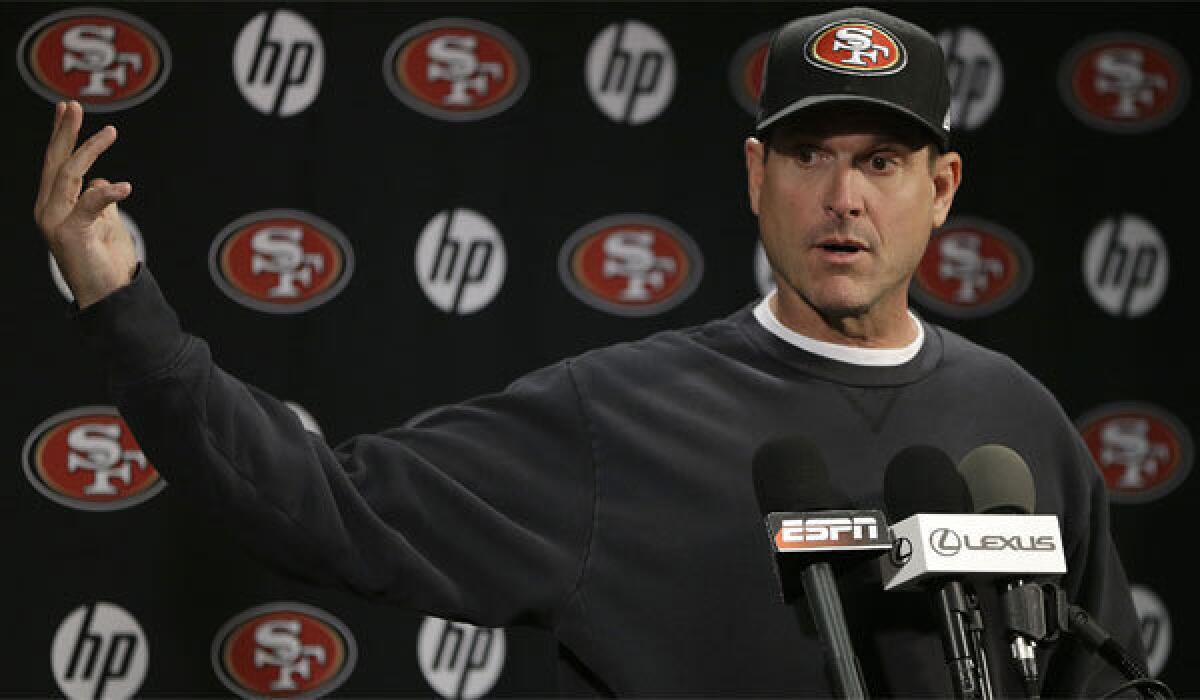 San Francisco Coach Jim Harbaugh, shown in January, said he has no intention of leaving the 49ers before his contract expires.