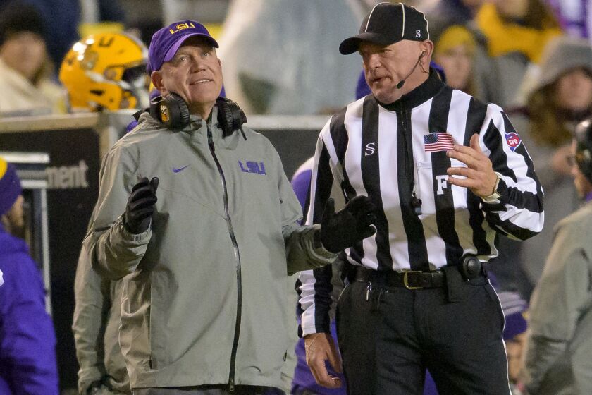 LSU coach Brian Kelly listens to an official on sideline during the second half the team's NCAA college football game against UAB in Baton Rouge, La., Saturday, Nov. 19, 2022. (AP Photo/Matthew Hinton)