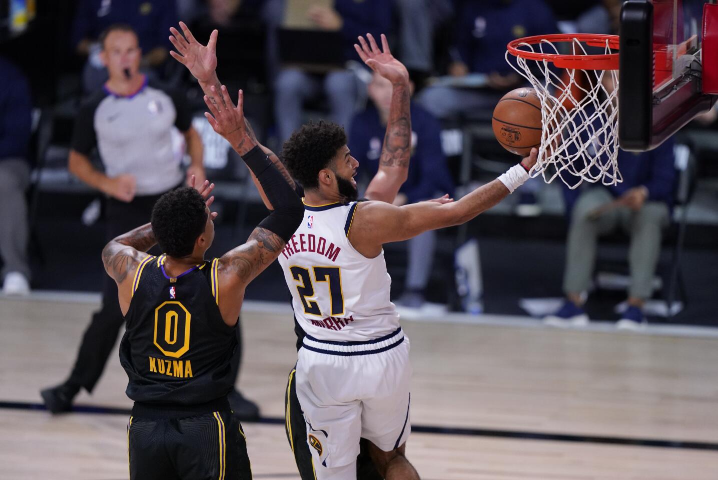 Nuggets guard drives down to the basket against Lakers forward Kyle Kuzma during Game 2.