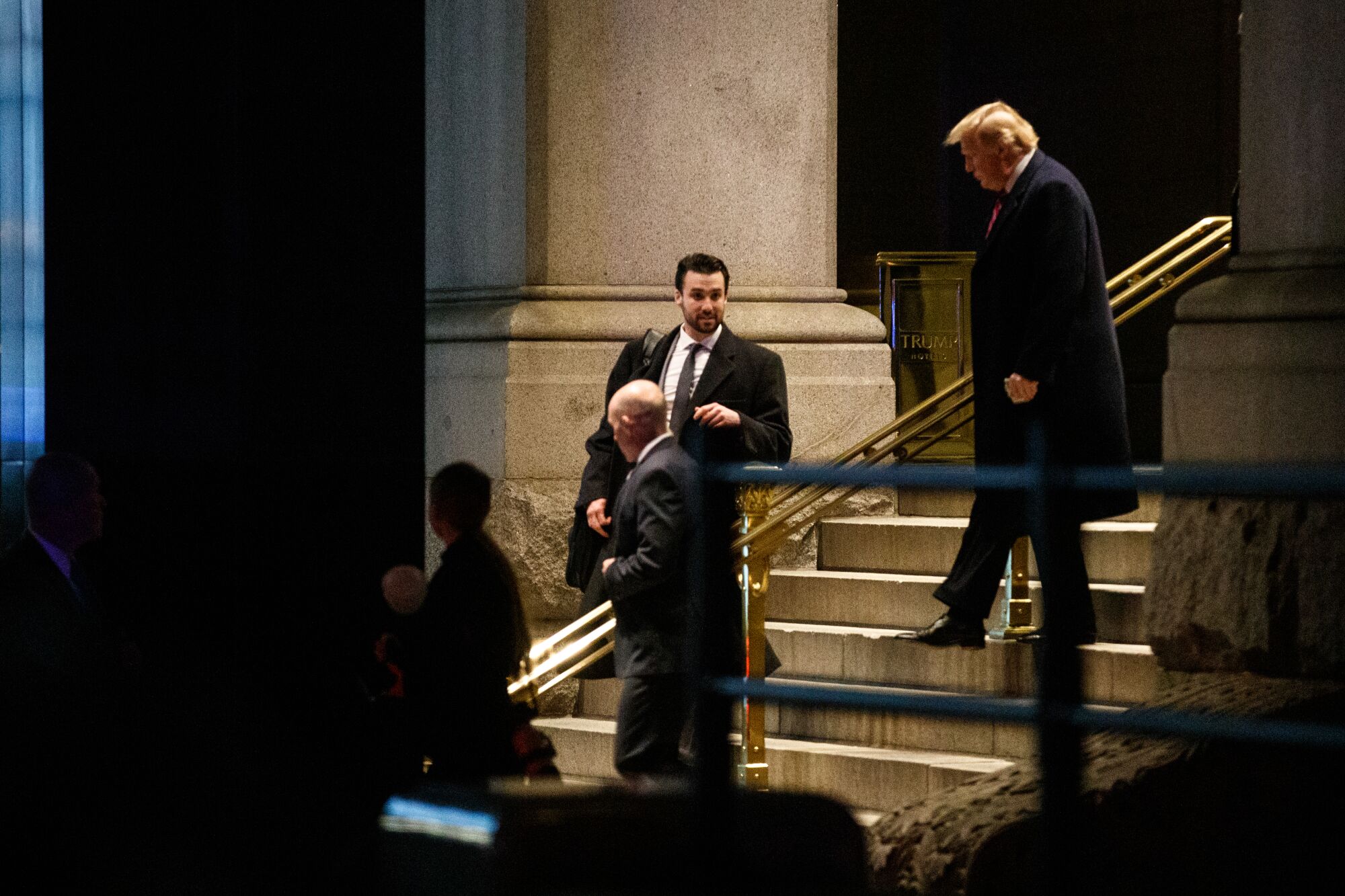 Donald Trump walks down stairs.