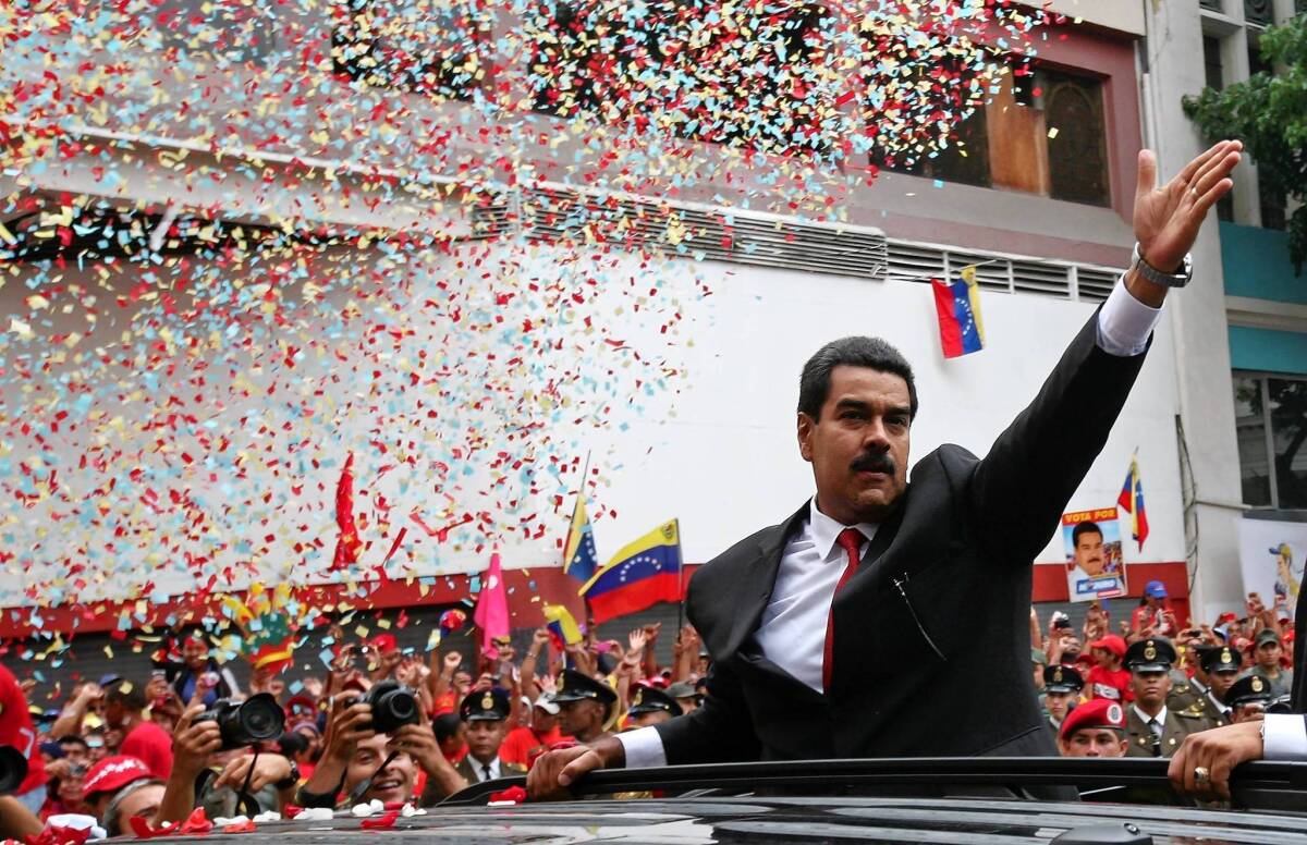 Nicolas Maduro waves to supporters before is swearing-in Friday as Venezuela's president.