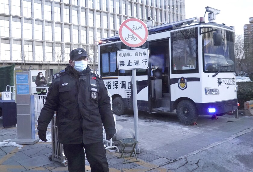 A security officer watches over the entrance of the Crowne Plaza Sun Palace hotel.