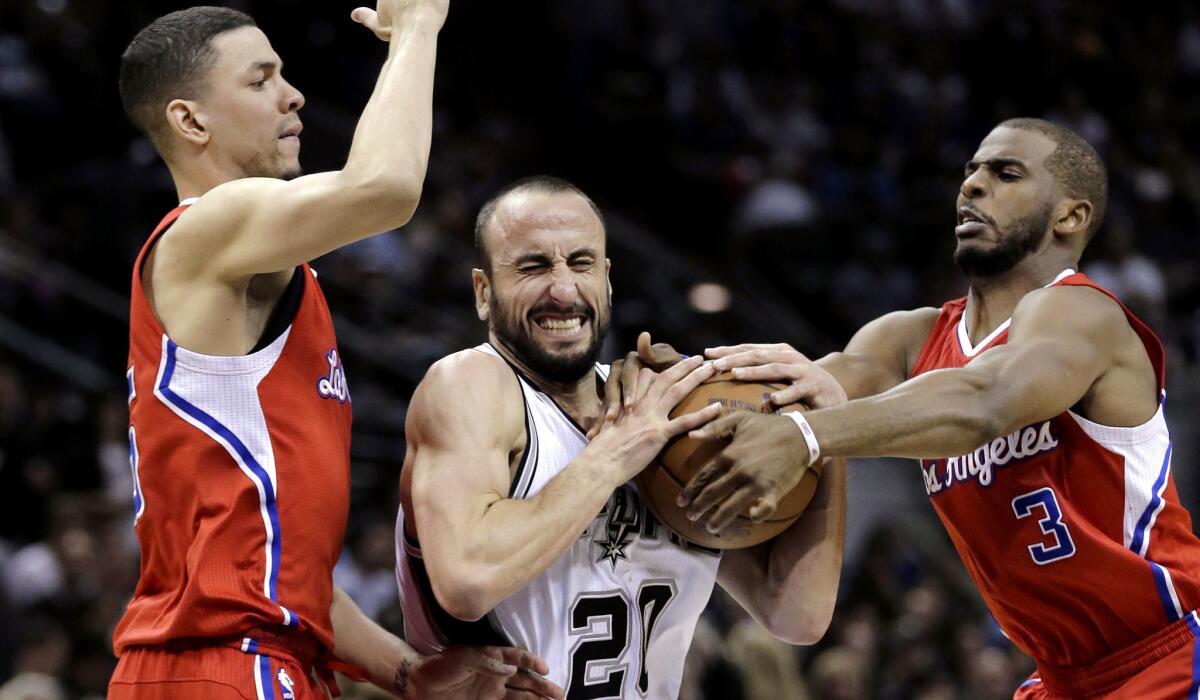 Spurs guard Manu Ginobili tries to split the defense of Clippers guards Austin Rivers, left, and Chris Paul in the second half of Game 3.