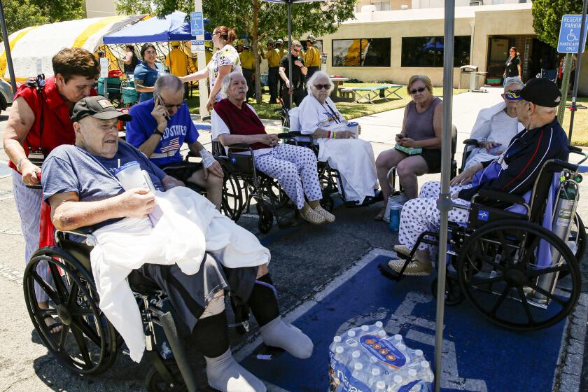 Patients rest under a shade of tent after being evacuated from Ridgecrest Regional Hospital after city was hit by a 6.4 earthquake.