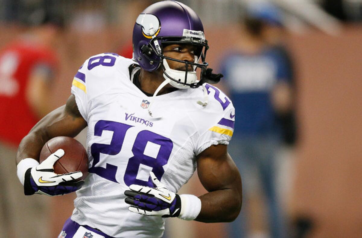 Minnesota Vikings running back Adrian Peterson warms up before the game against the Lions on Sunday in Detroit.