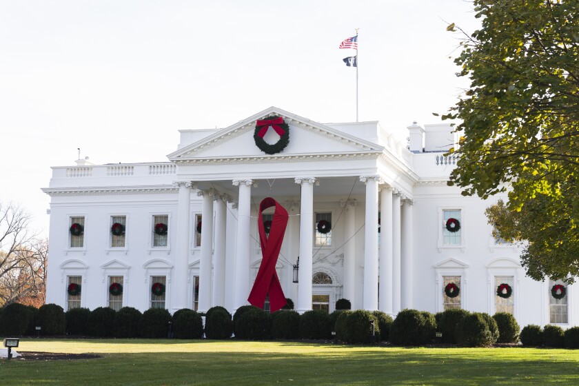 The North Portico of the White House is adorned with a huge red ribbon to commemorate the annual World AIDS Day