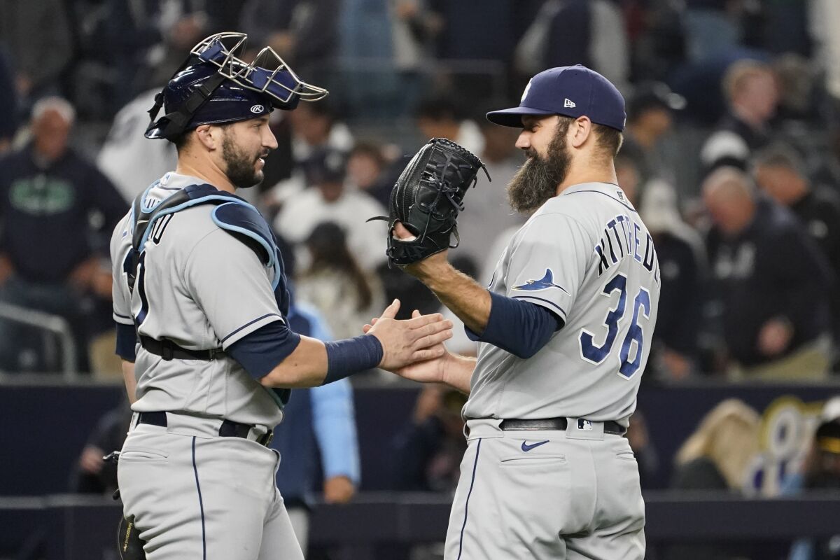Tampa Bay Rays pitcher Andrew Kittredge (36) and catcher Francisco Mejia celebrate after they defeated the New York Yankees in a baseball game, Friday, Oct. 1, 2021, in New York. The Rays won 4-3. (AP Photo/Mary Altaffer)