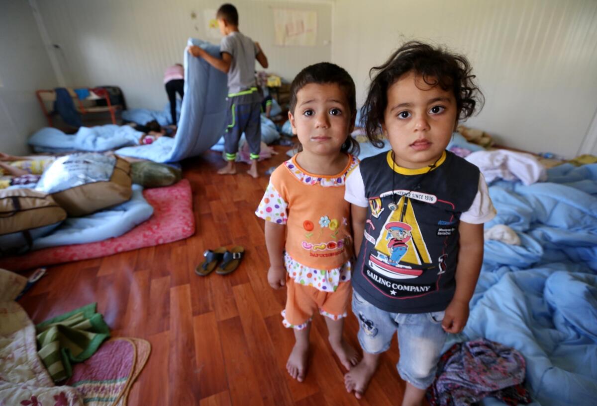 Two of the thousands of Iraqi Christian children forced to flee to Kurdish territory earlier this month with their families ahead of an onslaught by Sunni Islamic militants.