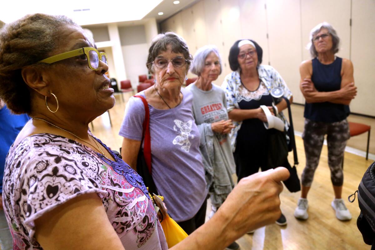 Carolynn Middleton, left, gestures while speaking as others look on