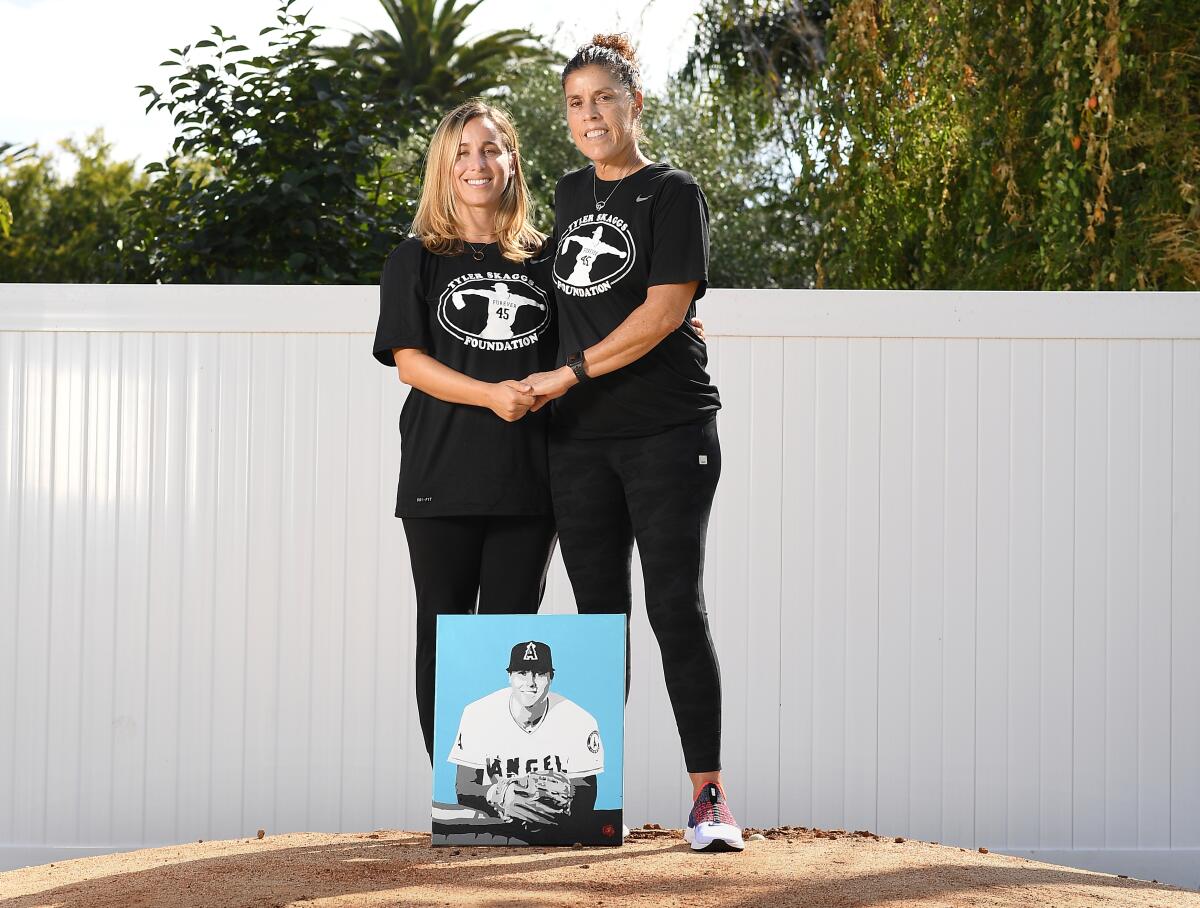 Tyler Skaggs wife, Carli Skaggs and his mother Debbie stand on a pitchers mound in the backyard of the home he grew up in.