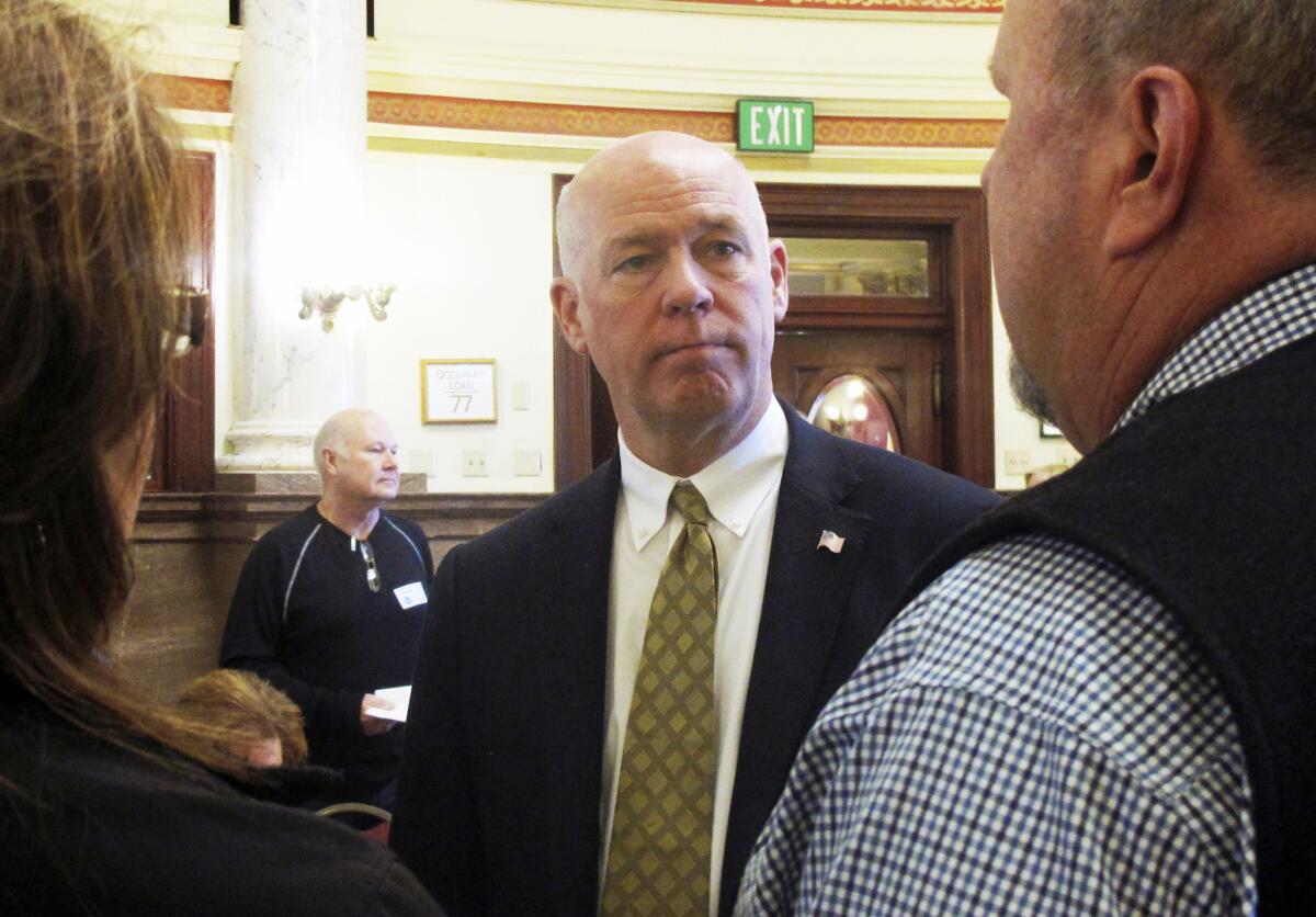 Greg Gianforte speaks with Republican delegates before a candidate forum in Helena, Mont.