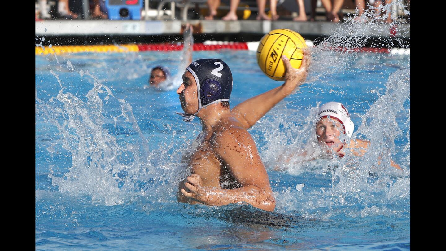 Newport's Makoto Kenney shoots and scores for the Sailors in non-league water polo game action against Laguna Beach on Tuesday.