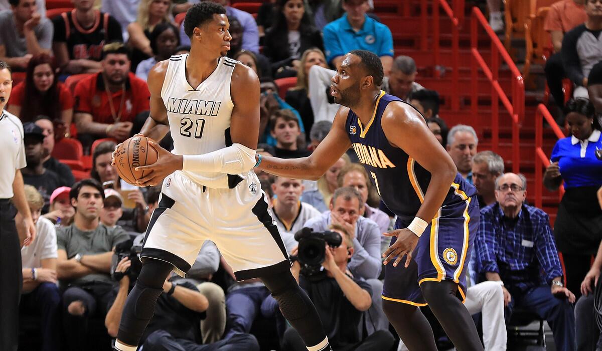 The Miami Heat's Hassan Whiteside, center, pulls away from the Indiana Pacers' Al Jefferson during a game Wednesday.