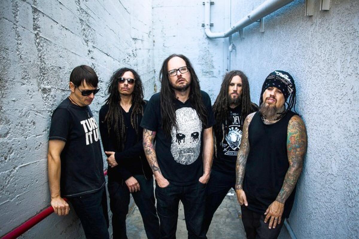 The members of Korn are Ray Luzier, left, James Shaffer, Jonathan Davis, Brian Welch and Reginald Arvizu.