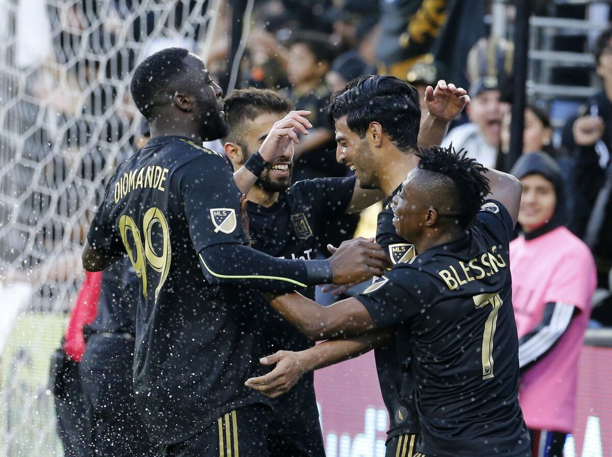 Los Angeles FC forward Carlos Vela, second from right, of Mexico, celebrates his goal with teammates in the second half of an MLS soccer match against Portland Timbers in Los Angeles, Sunday, March 10, 2019. The Los Angeles FC won 4-1.