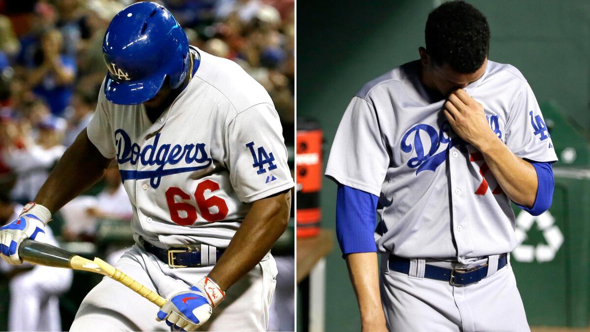 Dodgers right fielder Yasiel Puig reacts to striking out with two runners on base while starting pitcher Carlos Frias wipes his face after getting removed from the game against the Rangers on Monday night.