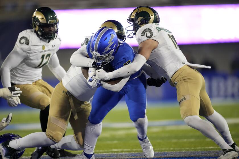 Air Force fullback Emmanuel Michel, center, is stopped, after a short gain, by Colorado State defensive lineman Troy Golden, left, and defensive back Henry Blackburn during the second half of an NCAA college football game Saturday, Nov. 19, 2022, at Air Force Academy, Colo. (AP Photo/David Zalubowski)