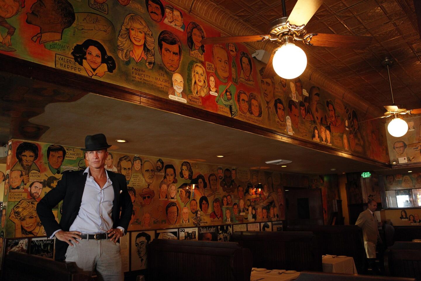 Palm co-owner Bruce Bozzi Jr., is surrounded by caricatures of celebrities that grace the walls the West Hollywood restaurant. After 40 years, Palm is moving to Beverly Hills, but most of the sketches won't be making the trip.