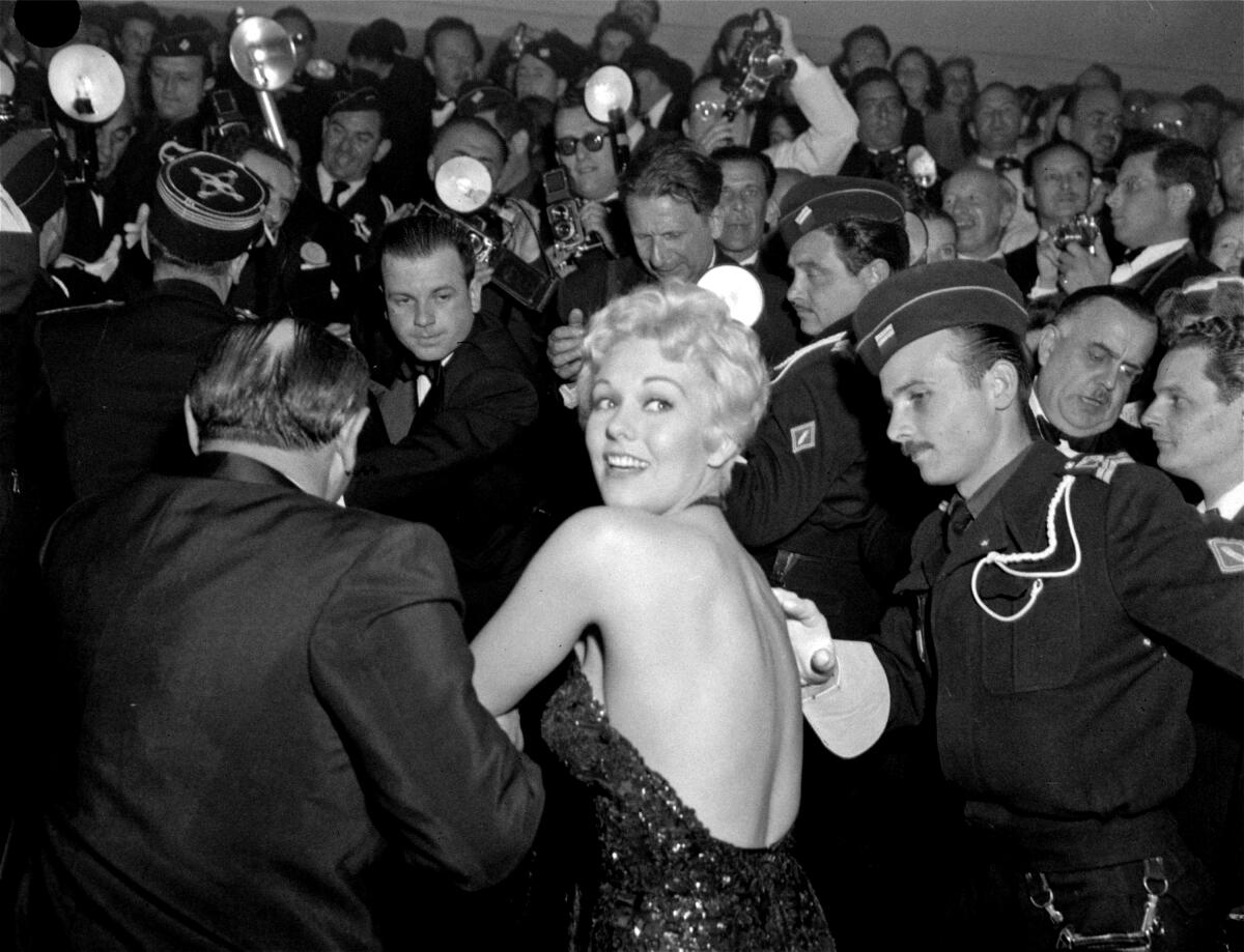A woman is escorted at a film festival.