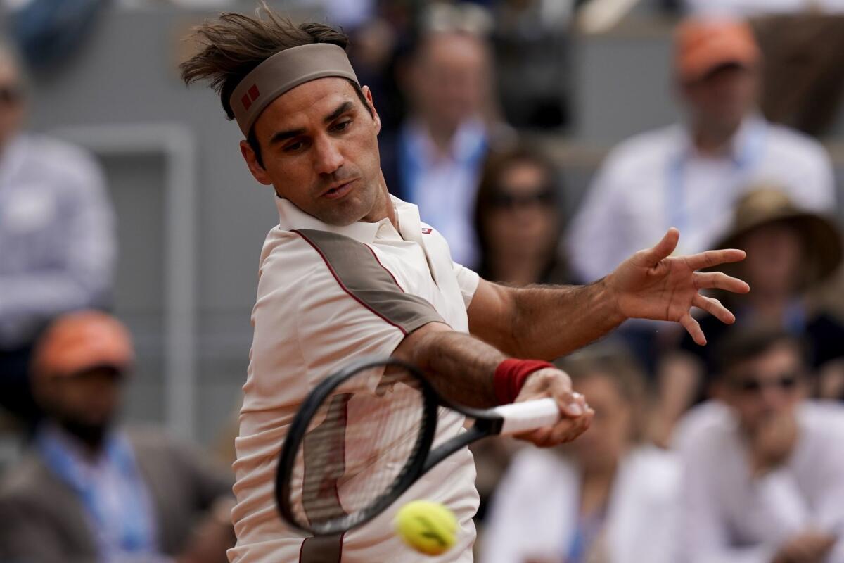 Roger Federer plays a forehand return to Oscar Otte during their men's singles second round match at the French Open in Paris on Wednesday.