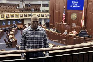 In this photo provided by the Innocence Project of Florida, Leonard Allen Cure poses from the floor of the Florida legislature in Tallahassee, Fla., in April 2023, on the day his compensation bill was passed. Cure, who spent more than 16 years in prison in Florida on a wrongful conviction, was shot and killed Monday, Oct. 156, by a sheriff's deputy in Georgia during a traffic stop, authorities and representatives said. (Innocence Project of Florida via AP)