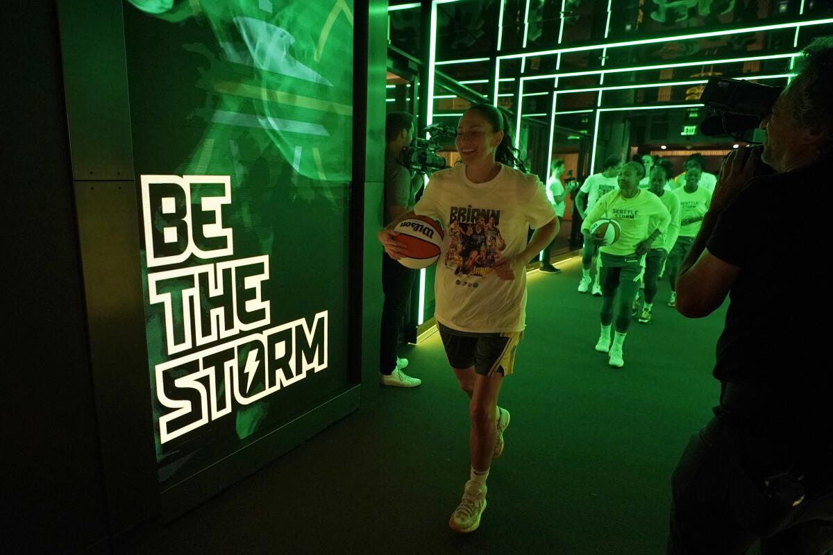Seattle Storm guard Sue Bird, center, walks out of the tunnel before a WNBA basketball game against the Minnesota Lynx, Wednesday, Aug. 3, 2022, in Seattle. Bird is retiring at the end of the 2022 season. (AP Photo/Ted S. Warren)