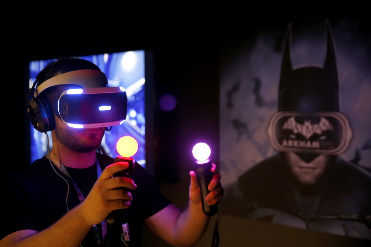 Jordan Maron plays Warner Bros. Interactive and DC Entertainment's "Batman: Arkham VR" during the Electronic Entertainment Expo.