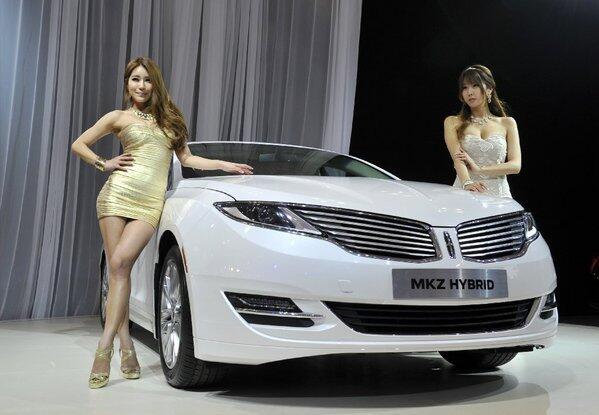 South Korean models pose with the all-new Lincoln MKZ Hybrid at the Seoul Motor Show last month. KBB says, "Lincoln's gas/electric mid-size sedan is as contemporary a vehicle we've seen from the automaker in a long time." City/highway/combined mpg: 45/45/45. MSRP: $36,800.