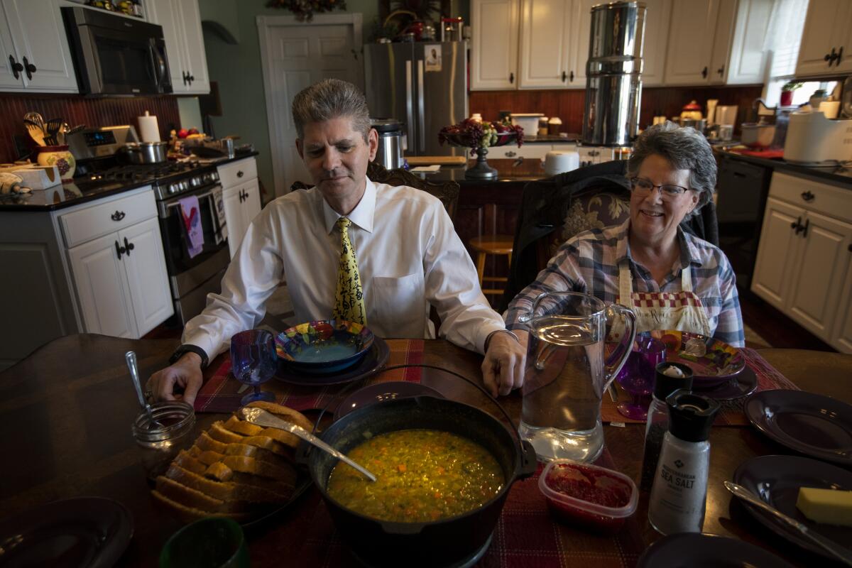 David and Sue Gillmore pray before eating lunch at home in Shelley, Idaho.