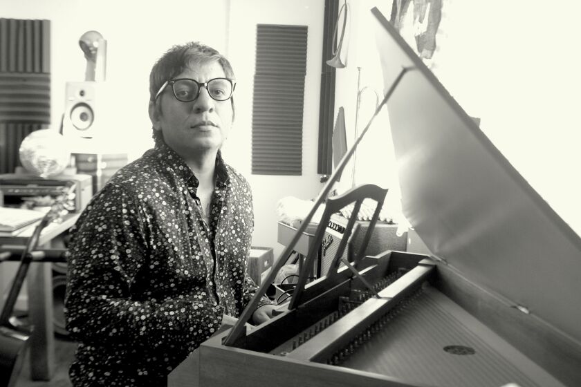 Francisco Morales, sitting at a piano and looking at the camera