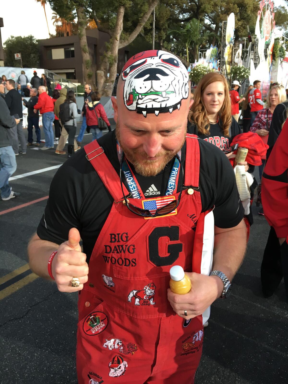 Trent Woods, known to University of Georgia football fans as 'Big Dawg Woods III,' poses for a picture along the parade route.