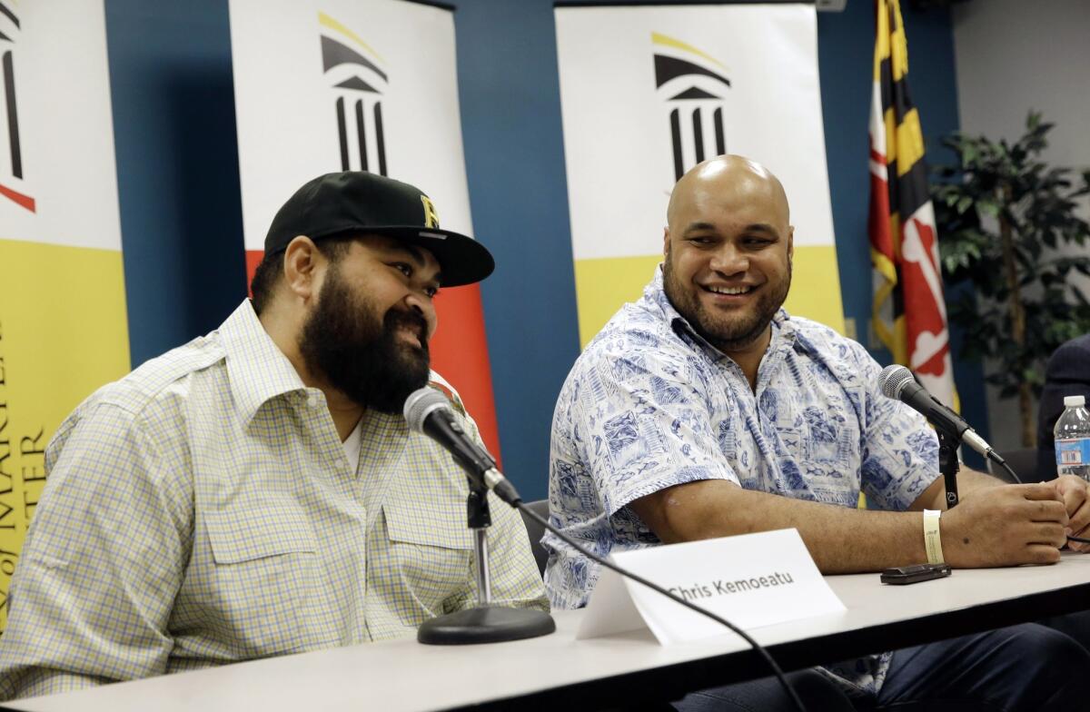 Former Pittsburgh Steeler Chris Kemoeatu, left, and his brother, Ma'ake, speak at a Sept. 17 news conference following their successful kidney transplant surgery.