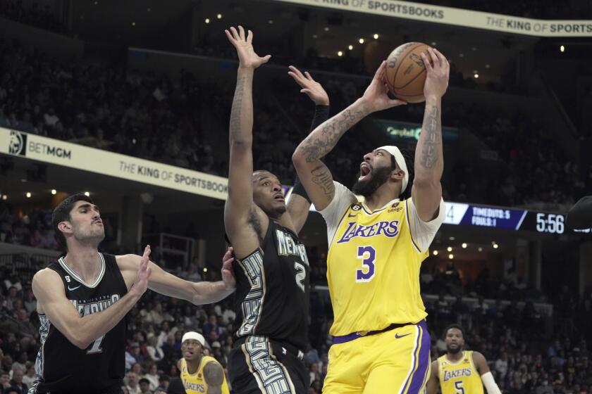 Memphis Grizzlies Xavier Tillman Sr. (2) defends against Los Angeles Lakers Anthony Davis (3) going up for a shot in the first half of an NBA basketball game, Tuesday, Feb. 28, 2023, in Memphis, Tenn. (AP Photo/Karen Pulfer Focht)