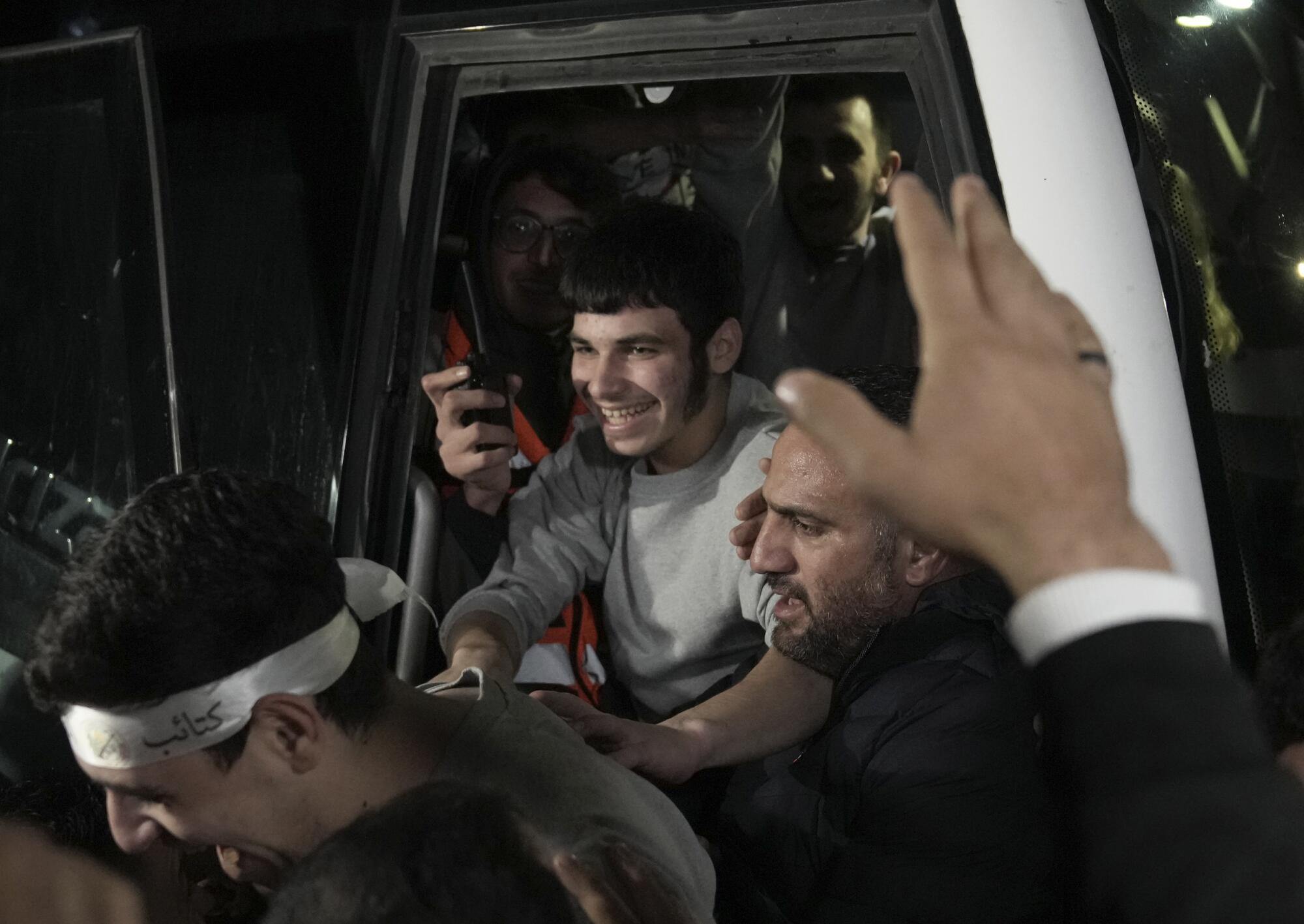 Released Palestinians smile as they arrive in the West Bank