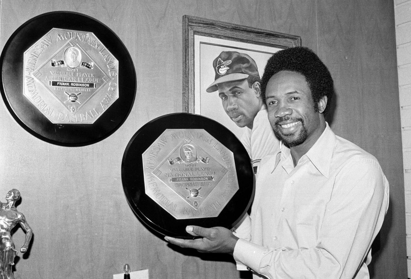 Frank Robinson displays trophies he received for being the Most Valuable Player in both the American and National Leagues at his home in Los Angeles in 1971.