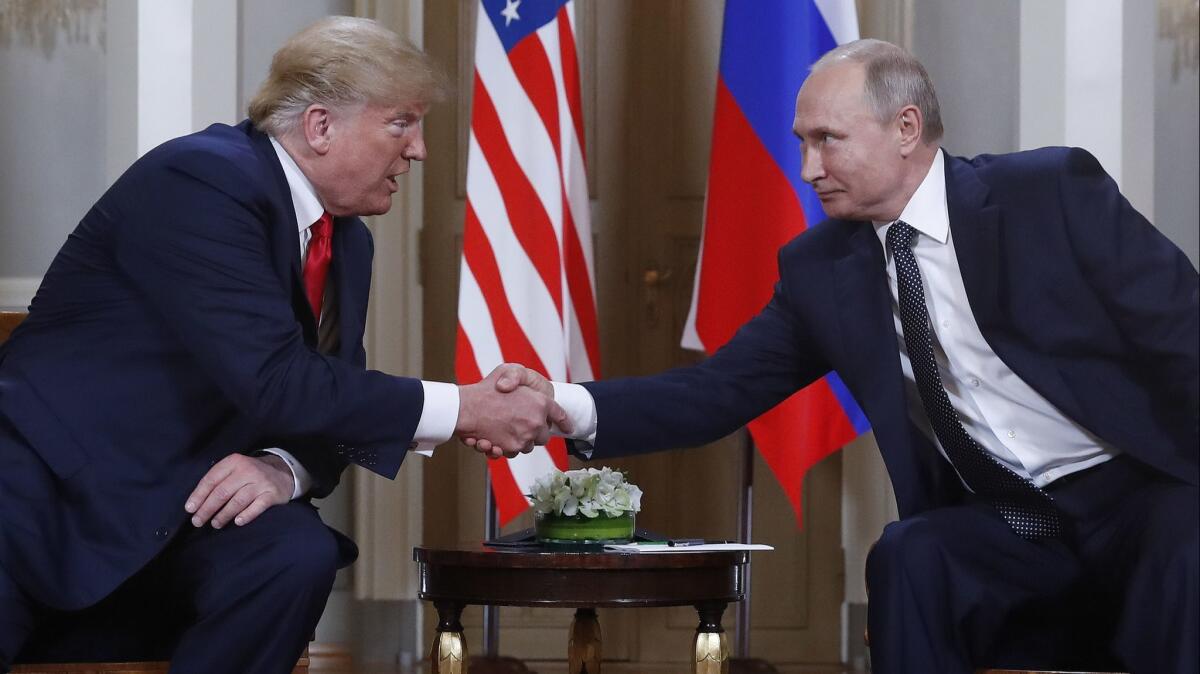 President Trump and Russian President Vladimir Putin greet each other at the beginning of a meeting at the Presidential Palace in Helsinki, Finland, on Monday.