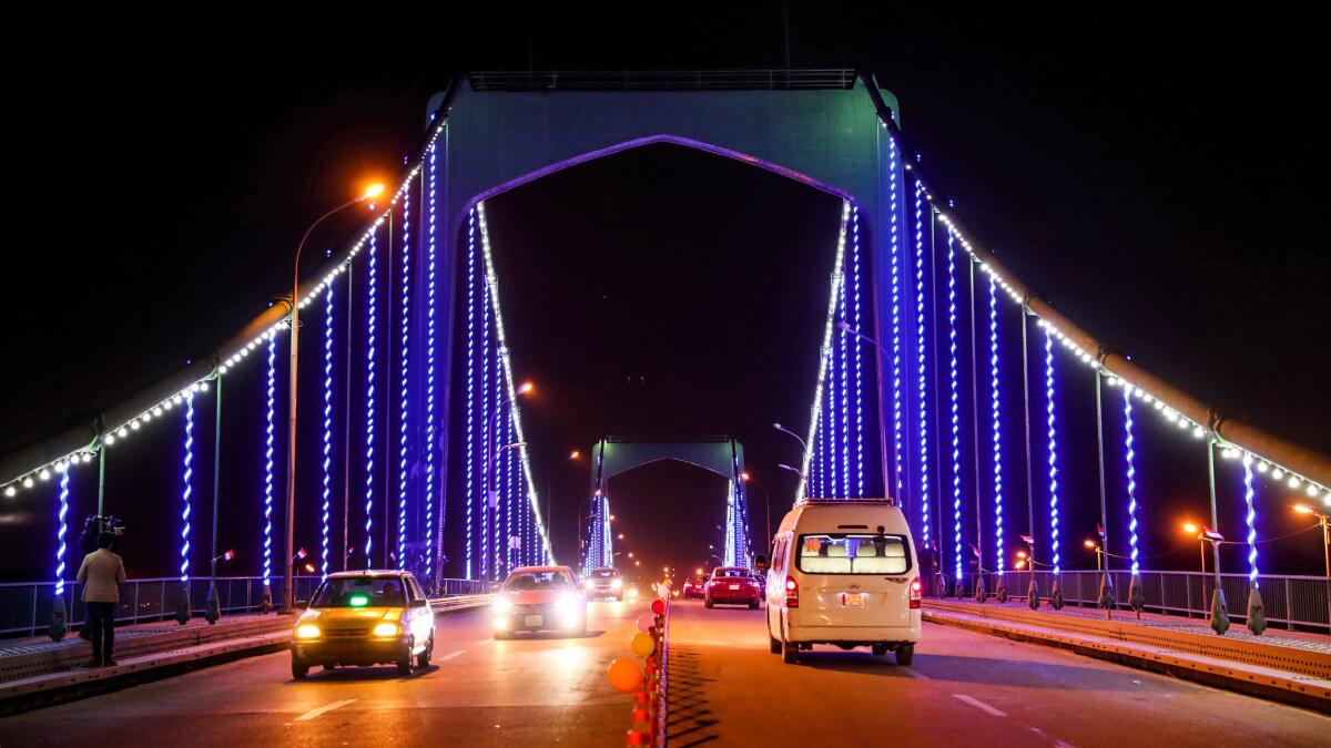 Cars cross the recently reopened 14th of July Bridge, a major thoroughfare linking Baghdad’s banks across the Tigris River. The bridge, which connects to the Green Zone, had been closed since the start of the Iraq war in 2003.