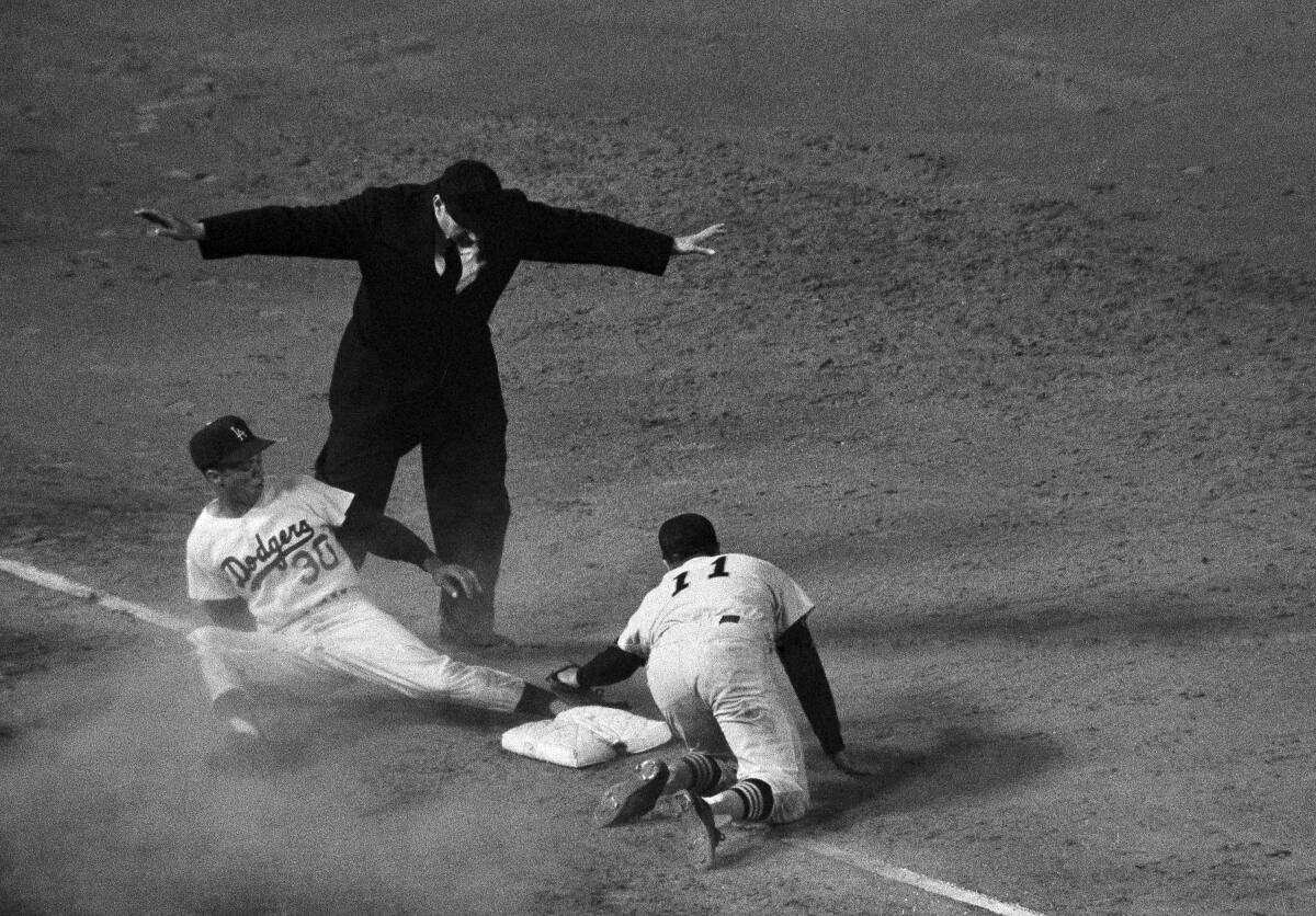 Maury Wills steals his 100th base of the 1962 season against Houston as Joey Amalfitano tries to apply the tag.
