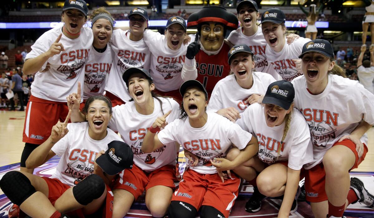 Cal State Northridge players celebrate after their 67-60 win over Hawaii in Big West women's tournament on Saturday.
