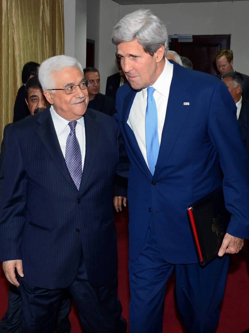 Secretary of State John F. Kerry, right, walks with Palestinian Authority President Mahmoud Abbas as they head to a meeting in Ramallah, West Bank.
