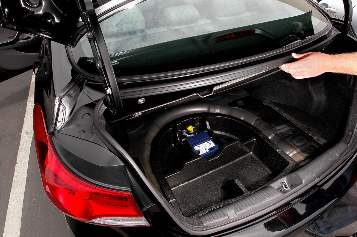 A tire inflator kit replaced a spare tire in the Hyundai Elantra. AAA wants automakers to keep spare tires as standard equipment.