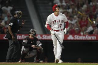 Shohei Ohtani looks up and reacts after hitting a deep home run during the Angels' loss 