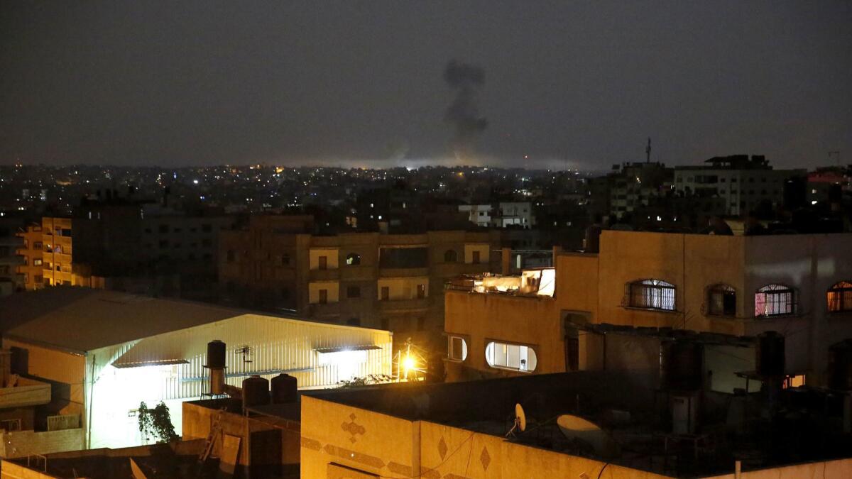 Smoke rises following Israeli strikes on Gaza City early on May 30.