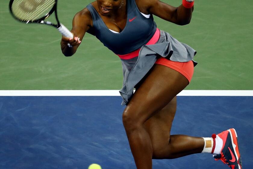 Serena Williams returns a shot during her first-round victory over Francesca Schiavone at the U.S. Open on Monday.