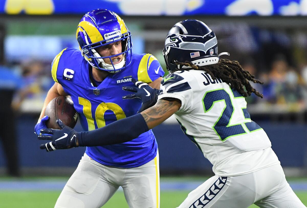  Rams receiver Cooper Kupp stiff-arms Seahawks cornerback Sidney Jones.