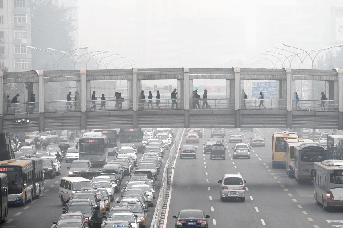 Thick smog shrouds Beijing in October. President Obama's visit has prompted the Chinese government to take strict anti-pollution measures, curbing car use and factory emissions for 10 days.