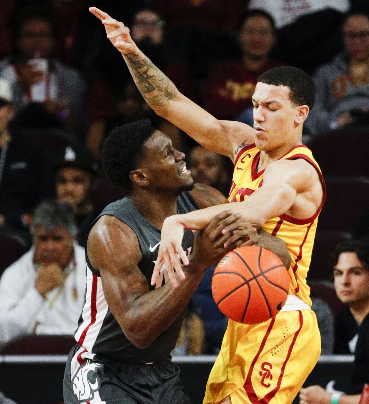 USC's Kobe Johnson, right, knocks the ball away from Washington State's TJ Bamba on Thursday night. 