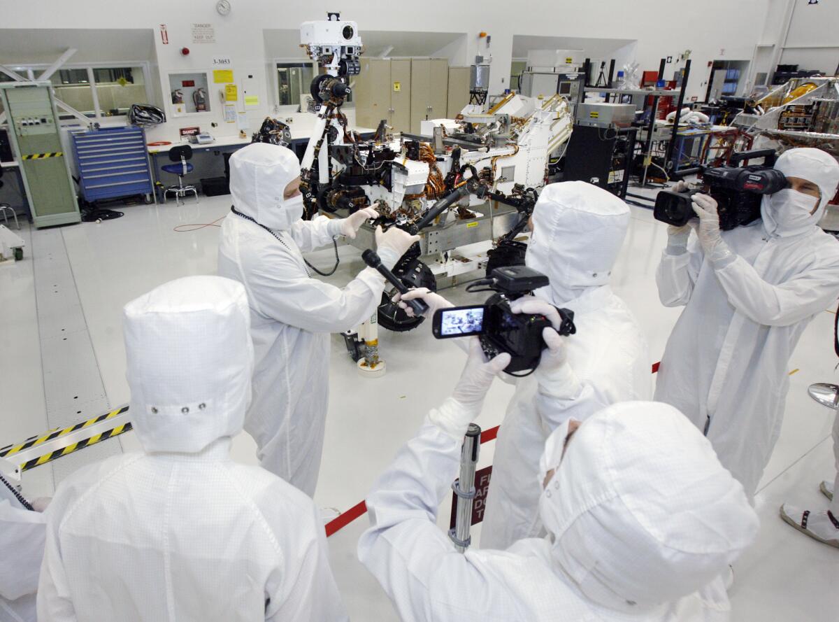 News media, including Bill Nye, the Science Guy, interview Peter Illsley, the rover integration lead, in the clean room at Jet Propulsion Laboratory on Monday, April 4, 2011, in La Cañada Flintridge where scientists assembled the Mars rover Curiosity.