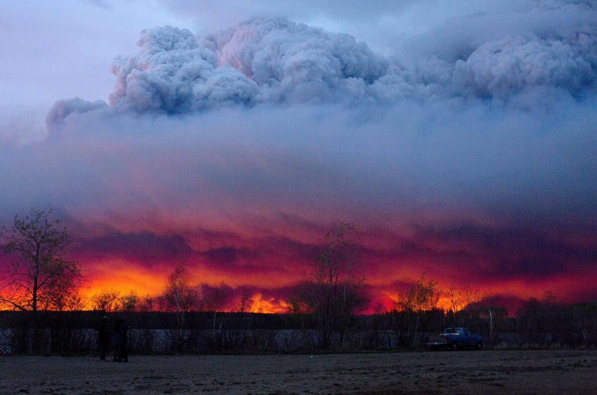 A wildfire moves toward the town of Anzac from Fort McMurray, Canada, on Wednesday.