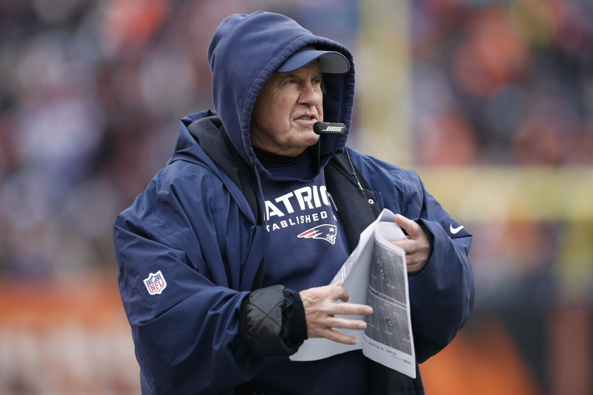 New England Patriots coach Bill Belichick stands on the sideline.